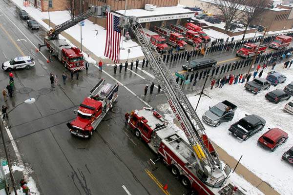A-Toledo-Fire-Department-truck-carries-a-flag-draped-coffin-p