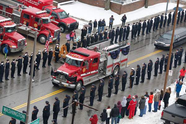 Toledo-Fire-Department-members-salute-as-fire-tr