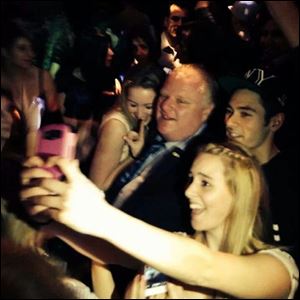 Toronto Mayor Rob Ford poses for photos at the Foggy Dew pub in Coquitlam, British Columbia.