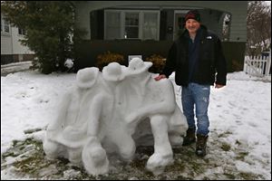 Larry Cready and his family spent about five hours on Friday crafting a snow memorial for the Toledo Fire Department.