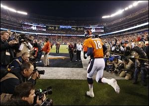Denver Broncos quarterback Peyton Manning runs onto the field before Super Bowl XLVIII against the Seattle Seahawks on Sunday in East Rutherford, N.J.