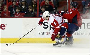 Detroit Red Wings left wing Justin Abdelkader, left, and Washington Capitals right wing Alex Ovechkin collide in the first period on Sunday in Washington.