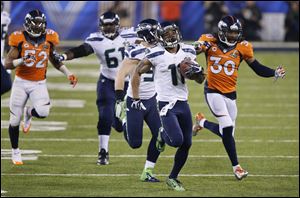 Seattle Seahawks wide receiver Percy Harvin returns the kickoff for a touchdown to start the second half against the Denver Broncos in Super Bowl XLVIII on Sunday in East Rutherford, N.J.