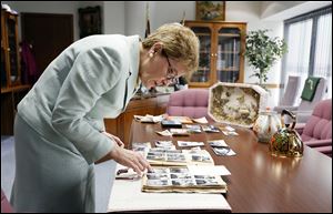 U.S. Rep. Marcy Kaptur (D., Toledo) looks over family pictures on her desk. Miss Kaptur’s grandparents were both born in Ukraine, and she worries about that nation’s future. She plans to bring some Ukrainian farmers here on a trade mission this month.    