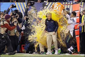 Seattle’s Pete Carroll is doused with sports drink in celebration of winning Super Bowl XLVIII.