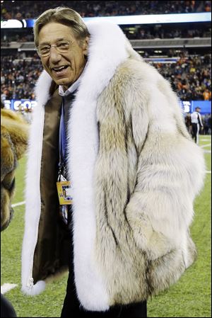 Former New York Jets quarterback Joe Namath walks on the field before the NFL Super Bowl XLVIII on Sunday.