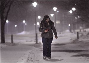 Elise Clark, a psychology major, walks to her car at the University of Toledo. She is going home to Addison, Michigan, a 90-minute drive in a snowstorm.