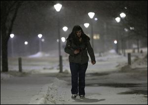 Elise Clark, a psychology major, walks to her car at the University of Toledo. She is going home to Addison, Michigan, a 90-minute drive in a snowstorm.