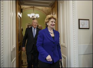Senate Agriculture Committee Chair Sen. Debbie Stabenow, D-Mich., followed by Sen. Patrick Leahy, D-Vt., arrives for a news conference on Capitol Hill in Washington.