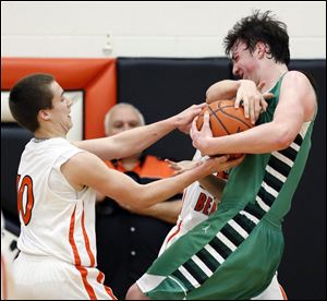 Ottawa Hills' Geoff Beans battles Gibsonburg's Jordan Kreglow (10) for the ball.