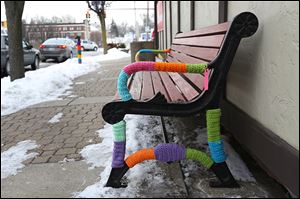 Even the feet of park benches didn't escape the yarn bomb. Forty people turned out Saturday to cover everything they could inyarn. The display is expected to remain up for about two months. 