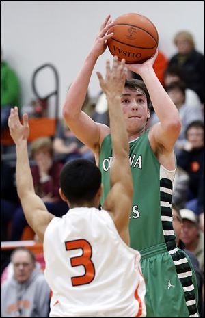 Ottawa Hills’ Geoff Beans shoots  over Gibsonburg’s Isaih Arriaga to top 1,000 career points  during the first quarter on Tuesday night in Gibsonburg. Beans scored a career-high 30 points and added seven rebounds in the Green Bears’ victory.