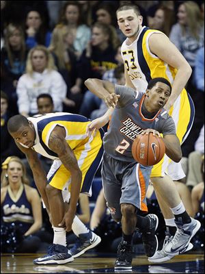 BG’s Anthony Henderson, center, steals the ball from UT’s Rian Pearson during their game last season at Savage Arena.