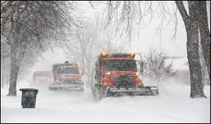 Snow plows work to clear 290th Street near Lehman Avenue as snow hammers the area on Wednesday. 