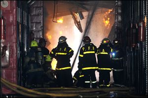 Firefighters work to extinguish a fire at the Iron Mountain warehouse in Buenos Aires, Argentina, today.