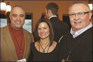Gus Mancy, left, ticket co-chair Mindy Romanoff, center, and Jim Cameron, right, attended the Taste of The Nation kickoff event at Vistula City Club in Toledo. 