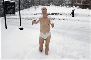 A statue of a man sleepwalking in his underpants is surrounded by snow on the campus of Wellesley College, in Mass. The sculpture entitled 