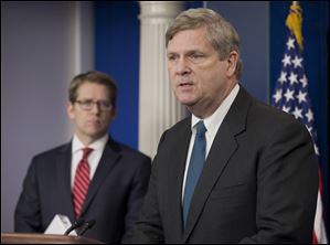Agriculture Secretary Tom Vilsack, right, accompanied by White House press secretary Jay Carney, announces new climate zones to help farmers deal with climate change.administration is creating seven regional 