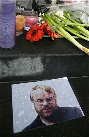 A makeshift memorial is seen, Monday, Feb. 3, 2014, outside the building where the body of actor Philip Seymour Hoffman was found in New York. Hoffman, 46, was found dead Sunday in his apartment. 