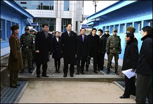 Head of South Korean working-level delegation Lee Duk-haeng, center, prepares to cross a border line to hold a meeting with North Korea at Tongilgak in the North Korean side of Panmunjom which has separated the two Koreas since the Korean War.
