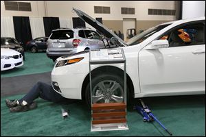 A 2014 Acura TL AWD gets some final preparations in the lead-up to the 2014 Toledo Auto Show at the SeaGate Convention Centre in downtown Toledo.  The show will run today through Sunday.