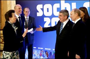 International Olympic Committee member Princess Anne of Great Britain, left, greets Russian President Vladimir Putin, right, IOC President Thomas Bach, second from right, and Sochi 2014 Olympics President Dmitry Chernyshenko, second from left, at an event welcoming IOC members ahead of the upcoming 2014 Winter Olympics at the Rus Hotel, Tuesday.