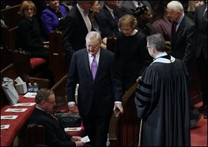 Former Vice President Walter Mondale arrives at the memorial service for his wife, Joan Mondale, at the Westminster Presbyterian Church in Minneapolis, followed by former President Jimmy Carter and former first lady Rosalynn Carter.
