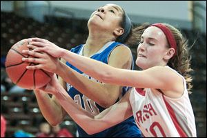 Anthony Wayne's Jasmine Bonivel, left, is fouled on her way to the basket by Central Catholic's Alex Matus.