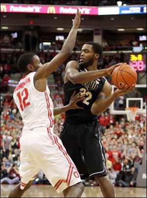 Ohio State's Sam Thompson (12) guards Purdue's Errick Peck (32) during the first half.