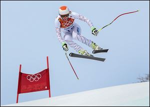 United States' Bode Miller jumps during the men's downhill at the Sochi 2014 Winter Olympics, Sunday, Feb. 9, 2014, in Krasnaya Polyana, Russia.(AP Photo/Luca Bruno)