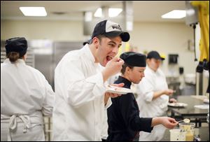 First year student Andy Nagy, Toledo, samples the desserts during baking class.
