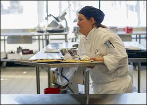 Second year student Beth Tolles, Rossford, prepares torts in the banquet/catering kitchen.