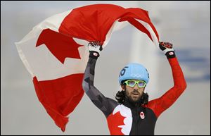 Charles Hamelin of Canada celebrates winning the men's 1500m short track speedskating final at the Iceberg Skating Palace today in Sochi, Russia.