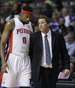 Detroit Pistons center Andre Drummond talks with interim head coach John Loyer.