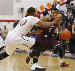 Scott’s Chris Harris dribbles past Rogers’ Fadil Robinson. Harris averages 23.2 points per game and scored 40 last Friday against Woodward.