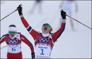 Norway's Maiken Caspersen Falla crosses the finish line to win gold in the final of the women's cross-country sprint today in Krasnaya Polyana, Russia.