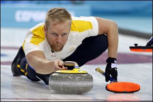 Sweden’s skip Niklas Edin delivers the rock during men's curling competition against Canada in Sochi, Russia today.
