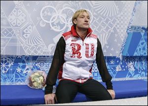 Evgeni Plushenko of Russia sits after competing in the men's team free skate figure skating competition at the Iceberg Skating Palace Sunday in Sochi.