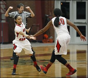 Rogers’ Keyanna Austin, left, and Akienreh Johnson celebrate during their City League semifinal win Wednesday night.