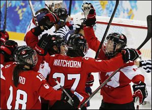 Hayley Wickenheiser of Canada, right, celebrates with her teammates after her goal against the Unites States during the third period.