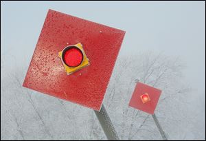 Red signals are a stark contrast to the fog and frost that envelop Cullen Park in Point Place.