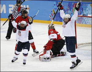 Hilary Knight, right, and Kelli Stack, left, of the United States celebrate Knight's goal against Canadian goalkeeper Charline Labonte during the second period.