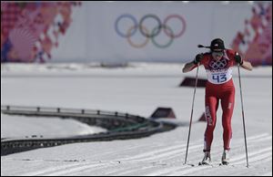 Poland's Justyna Kowalczyk skis as she is to win the gold during the women's 10K classical-style cross-country race.