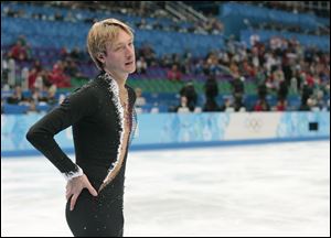 Evgeni Plushenko of Russia leaves the ice after pulling out of the men's short program figure skating competition due to illness at the Iceberg Skating Palace in Sochi, Russia.