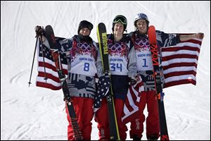 Men's ski slopestyle medalists from the United States Gus Kenworthy, left, silver, Joss Christensen, center, gold, and Nicholas Goepper, bronze, right,on the podium at the Rosa Khutor Extreme Park in Krasnaya Polyana, Russia.