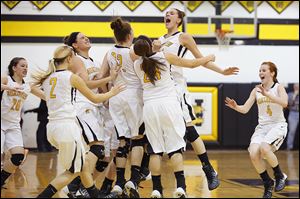 Northview’s Kendall McCoy, right, leaps into her teammates after the Wildcats beat Southview. McCoy hit the game-winning shot with seconds remaining as Northview swept Southview.