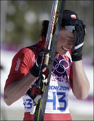 Poland's Justyna Kowalczyk bursts into tears after winning the women's 10K classical-style cross-country race at the 2014 Winter Olympics in Krasnaya Polyana, Russia.