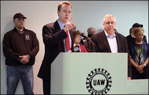 Democrat gubernatorial candidate Ed FitzGerald, left, is endorsed by UAW director Region 2B Ken Lortz, right, today at the UAW Headquarters in Maumee.