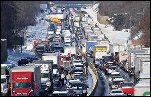 Traffic crashes involving multiple tractor trailers and dozens of cars have completely blocked one side of the Pennsylvania Turnpike outside Philadelphia and caused some injuries.