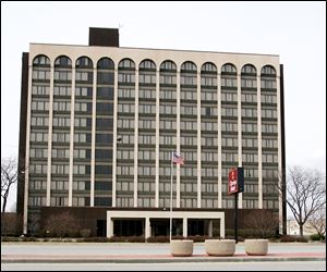 The city wants to acquire and demolish the shuttered Clarion Hotel on Reynolds Road to spur development.